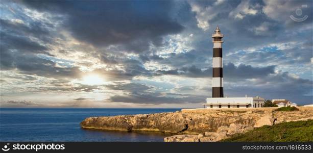 MINORCA ISLE - SPAIN - CIRCA AUGUST 2020  scenic Artrutx Lighthouse at sunset, famous landmark of the Isle