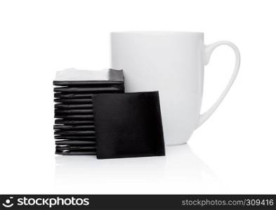 Mint chocolate thins on white background with tea cup.