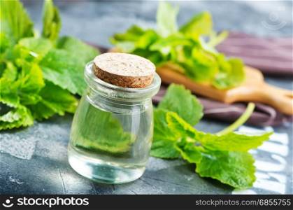 mint oil in bottle and on a table