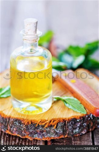 mint oil in glass bottle and on a table