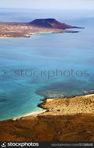 miramar del rio harbor rock stone sky cloud beach boat yacht water in lanzarote spain graciosa