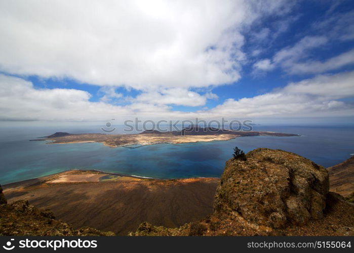 miramar del rio harbor rock stone sky cloud beach boat yacht water in lanzarote spain graciosa