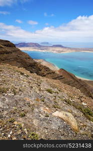 miramar del rio harbor rock stone sky cloud beach boat yacht water in lanzarote spain graciosa