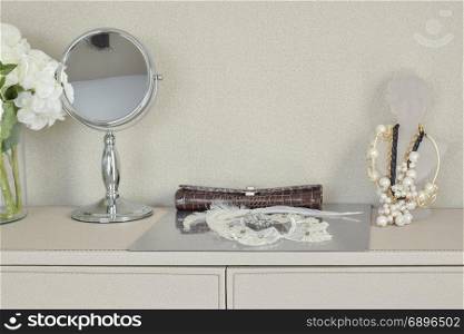 mirror,jewelry and makeup set on a table