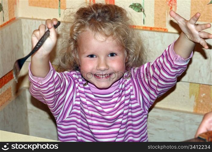 mischievous little girl in kitchen (ready and glad to eat)