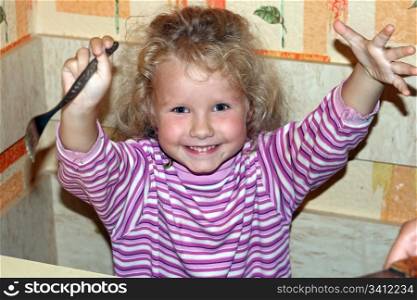 mischievous little girl in kitchen (ready and glad to eat)