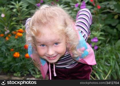 mischievous little girl in ornamental garden (ready to jump)