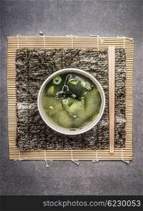 Miso soup on gray on gray stone background, top view