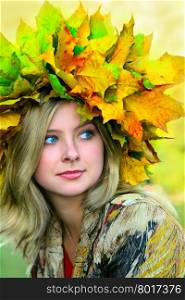 Miss Autumn. Beautiful blue-eyed woman with diadem made from yellow maple leaves