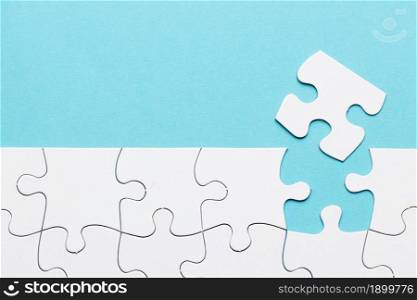 missing puzzle piece with white puzzle grid blue background. Resolution and high quality beautiful photo. missing puzzle piece with white puzzle grid blue background. High quality beautiful photo concept