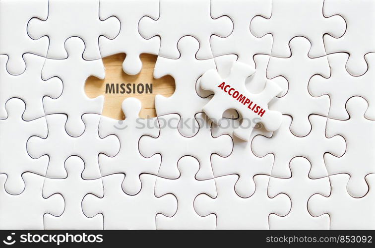 Mission and accomplish words on jigsaw puzzle background, business concept