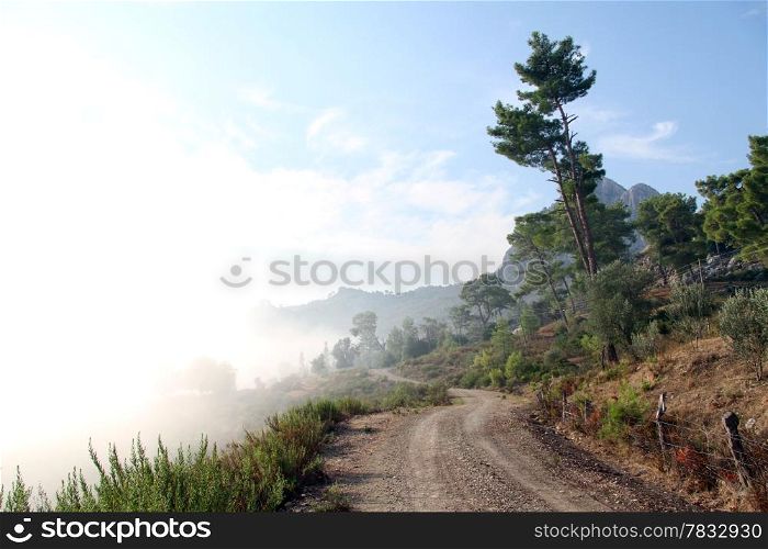 Mist and mountain dirt road in mountain area, Turkey
