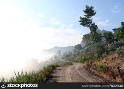 Mist and mountain dirt road in mountain area, Turkey