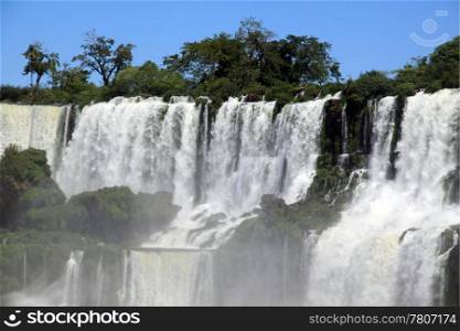 Mist and wide Iguazu waterfall in Argentina
