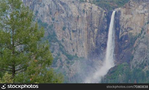 Mist from Yosemite falls blows along canyon