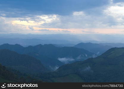 mist-shrouded mountains. High mountain complex. Fog in the morning and evening.