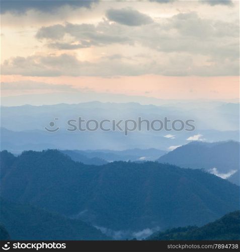 mist-shrouded mountains. High mountain complex. Fog in the morning and evening.