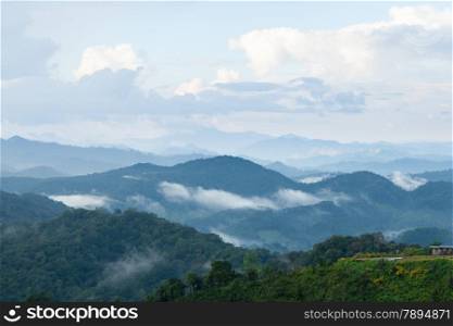 mist-shrouded mountains. High mountain complex. Fog in the morning and evening.