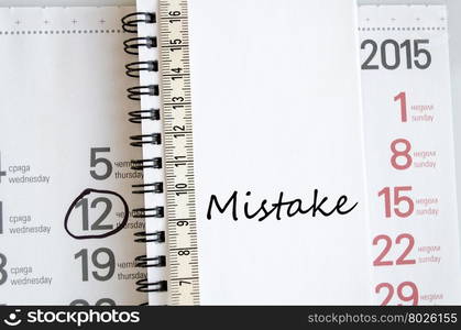 Mistake text concept over tape measure and calendar background&#xA;&#xA;