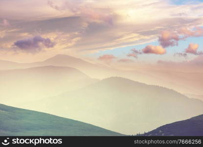 Misty mountain silhouette at sunrise