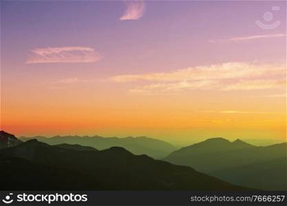 Misty mountain silhouette at sunrise