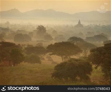 Misty sunrise over ancient architecture of old Buddhist Temples at Bagan Kingdom, Myanmar (Burma). Two images panorama