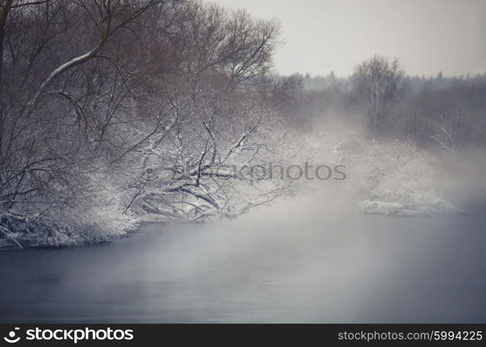 Misty winter river. Winter fog ober the river. Belarus