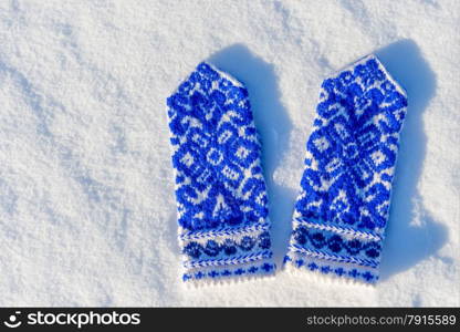 mittens with beautiful pattern on the snow