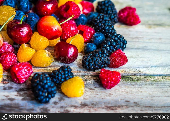 Mix of berries on wooden background