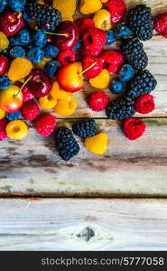 Mix of berries on wooden background