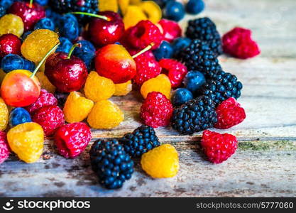 Mix of berries on wooden background