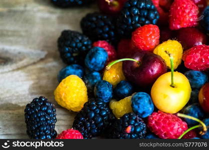 Mix of berries on wooden background