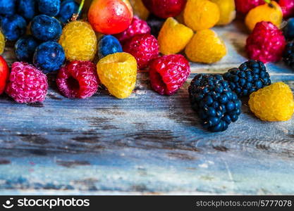 Mix of berries on wooden background