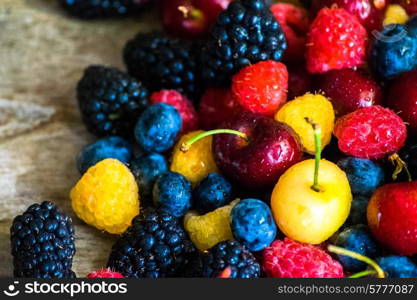 Mix of berries on wooden background