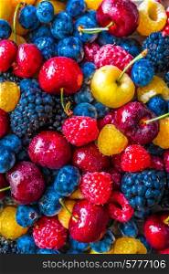 Mix of berries on wooden background
