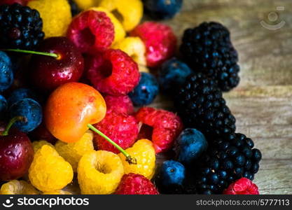 Mix of berries on wooden background