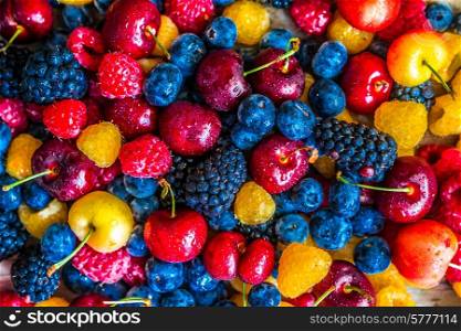 Mix of berries on wooden background