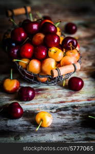 Mix of cherries on wooden background