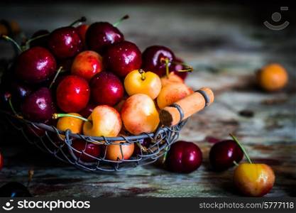 Mix of cherries on wooden background