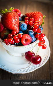 Mix of fresh berries in a cup of tea