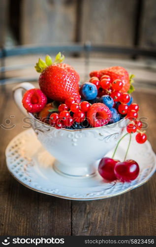 Mix of fresh berries in a cup of tea