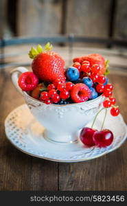 Mix of fresh berries in a cup of tea