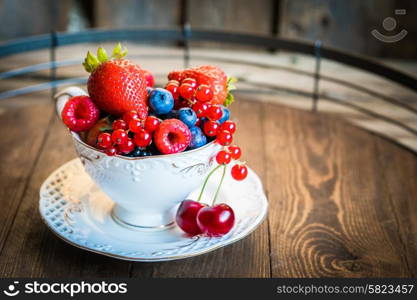 Mix of fresh berries in a cup of tea