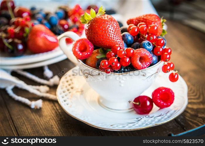 Mix of fresh berries in a cup of tea