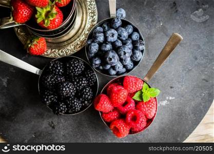 Mix of fresh berries on rustic background