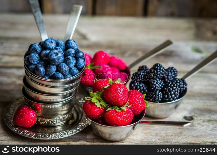 Mix of fresh berries on rustic background