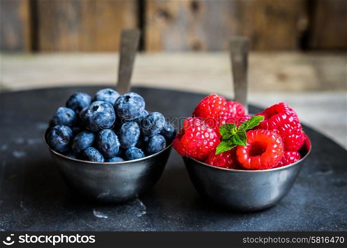 Mix of fresh berries on rustic background