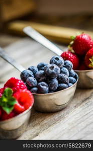 Mix of fresh berries on rustic background