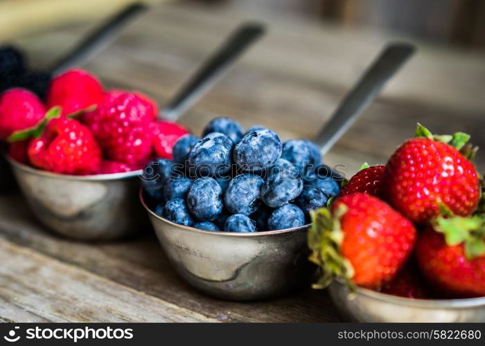 Mix of fresh berries on rustic background