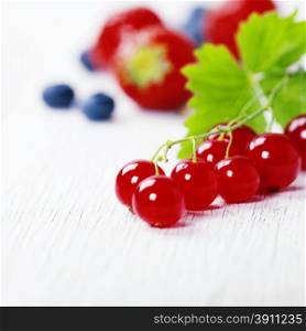 Mix of fresh berries on rustic wooden background